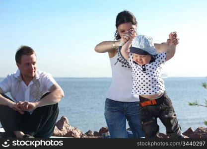 happy family on picnic sea on background