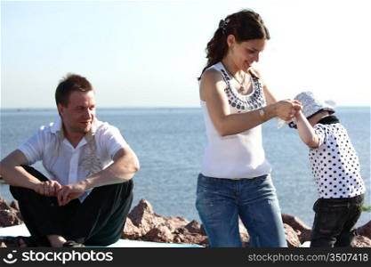 happy family on picnic sea on background