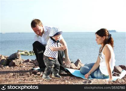 happy family on picnic sea on background