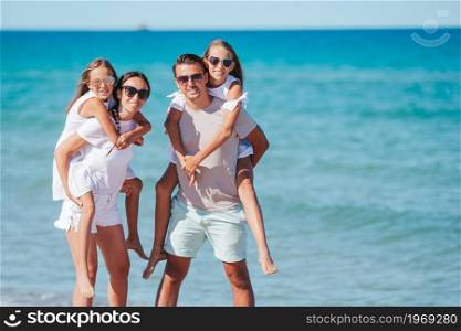 Happy family on the beach at summer vacation. Happy family on the beach during summer vacation