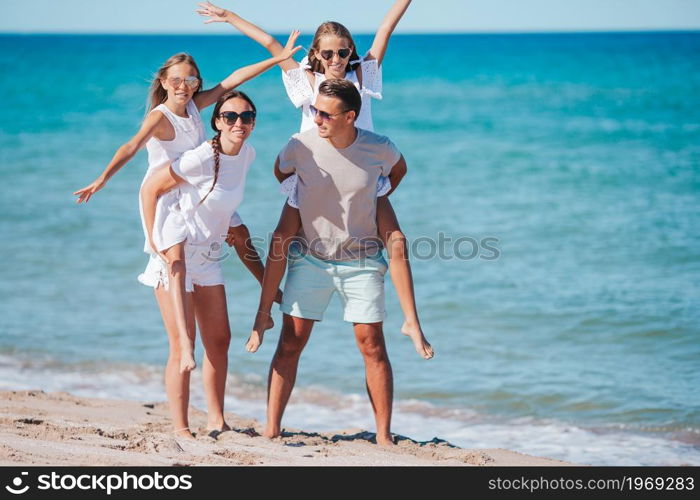 Happy family on the beach at summer vacation. Happy family on the beach during summer vacation