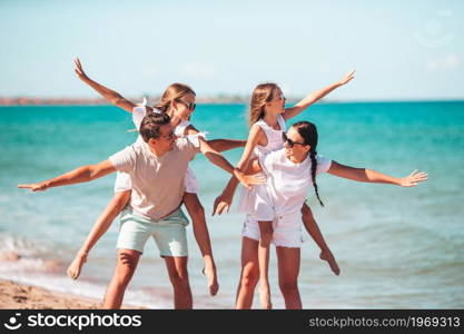 Happy family on the beach at summer vacation. Happy family on the beach during summer vacation