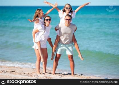 Happy family on the beach during summer vacation. Young family on vacation have a lot of fun