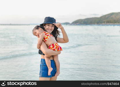 happy family on the beach. mother and child daughter at sea