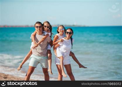 Happy family on the beach on summer vacation. Happy family on the beach during summer vacation