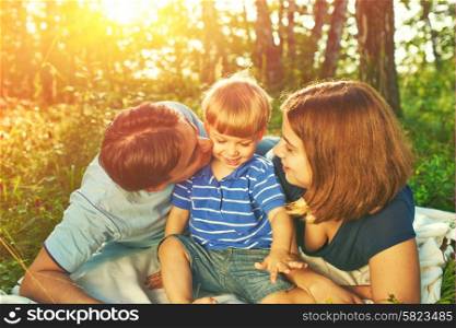 Happy family outdoors, father, mother and son
