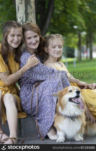 happy family outdoors. mother and daughters look at the camera 