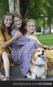 happy family outdoors. mother and daughters look at the camera 