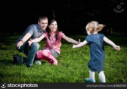 Happy Family Playing On The Grass