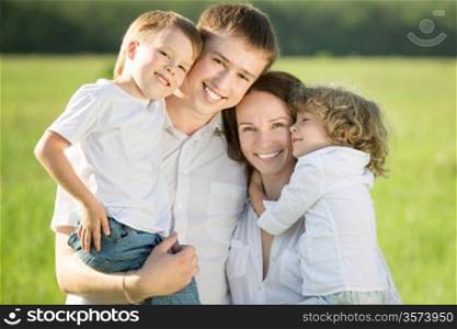 Happy family playing outdoors in spring green field