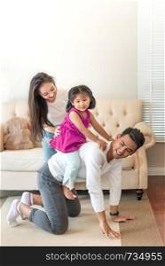 happy family playing together in living room at home. Young happy family