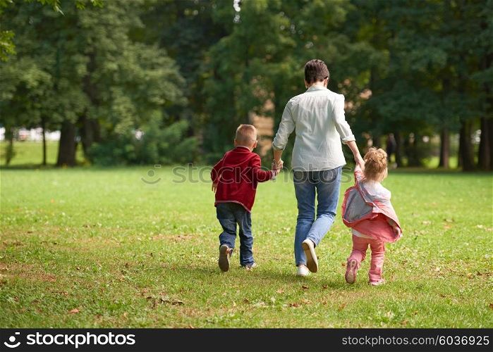 happy family playing together outdoor in park mother with kids running on grass