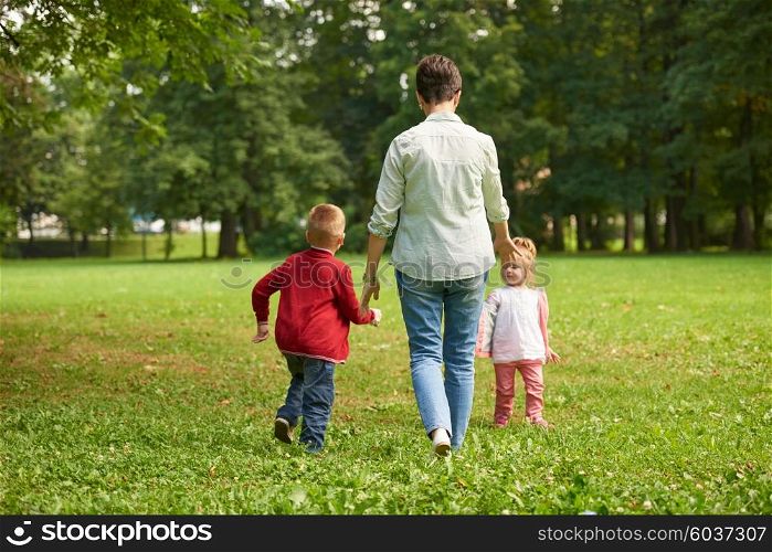 happy family playing together outdoor in park mother with kids running on grass