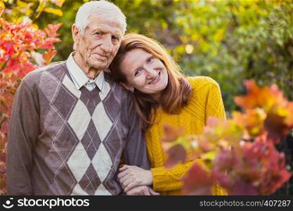 happy family. portrait of smiling senior man and granddaughter