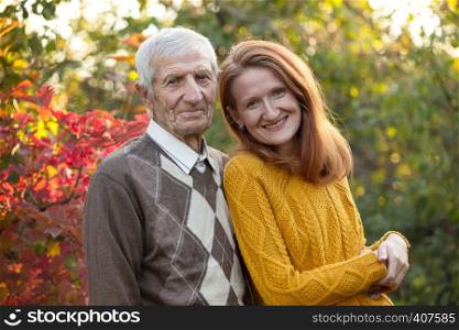 happy family. portrait of smiling senior man and granddaughter