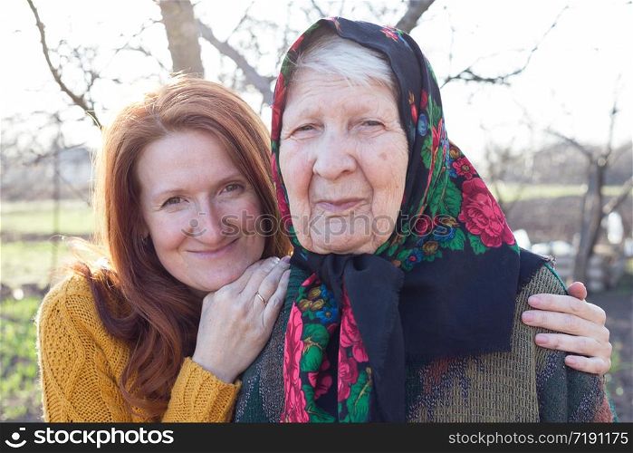 happy family. portrait of smiling senior woman and granddaughter