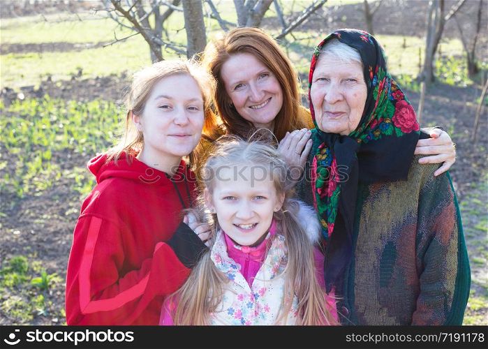 happy family. portrait of smiling senior woman, granddaughter and great granddaughters