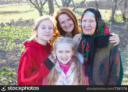 happy family. portrait of smiling senior woman, granddaughter and great granddaughters