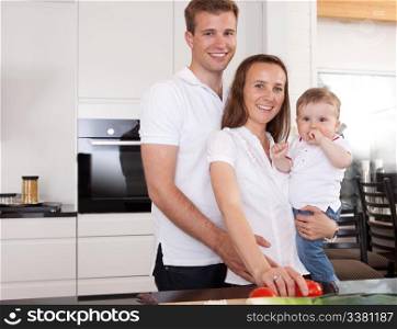 Happy family portrait with mother father and son in kitchen