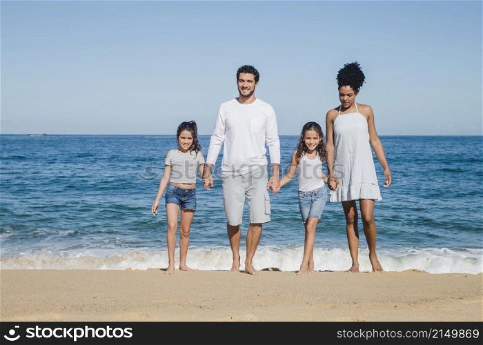 happy family posing holding hands