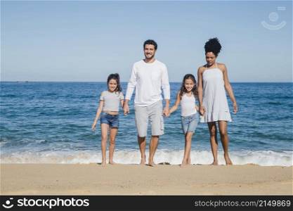 happy family posing holding hands