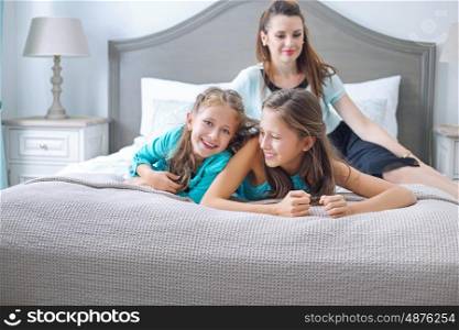 Happy family posing in the bedroom