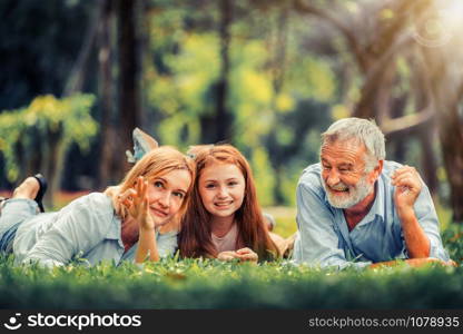 Happy family relaxing together in the park in summer. Concept of family bonding and relationship.