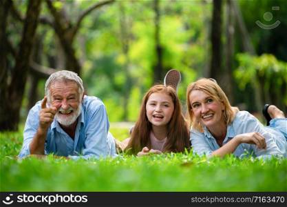 Happy family relaxing together in the park in summer. Concept of family bonding and relationship.