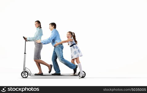 Happy family riding on scooter. Image of happy young family riding scooter