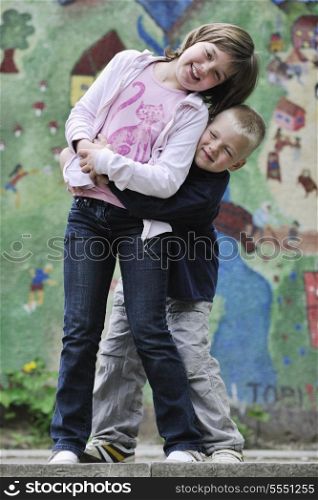 happy family sister and brother have fun and play games outdoor in park