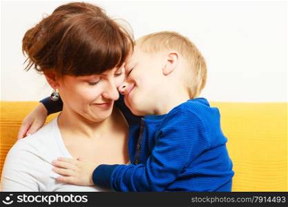 Happy family. Smiling blond son boy kid child hugging his mother expressing tender feelings. Love.
