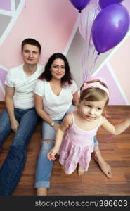 happy family - smiling mother, dad and little daughter