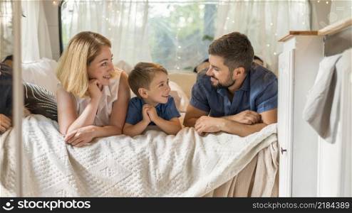 happy family spending time bed caravan