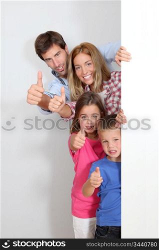 Happy family standing by whiteboard