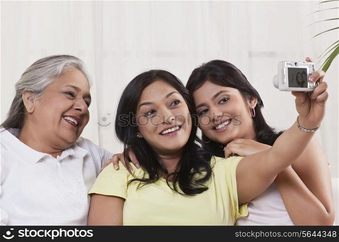 Happy family taking self-portrait with digital camera