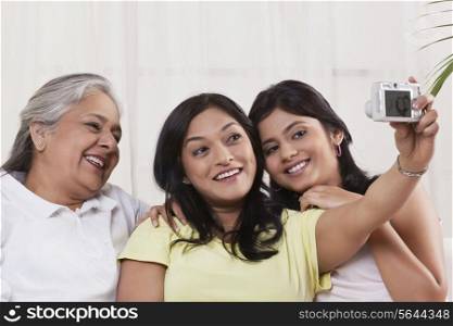 Happy family taking self-portrait with digital camera