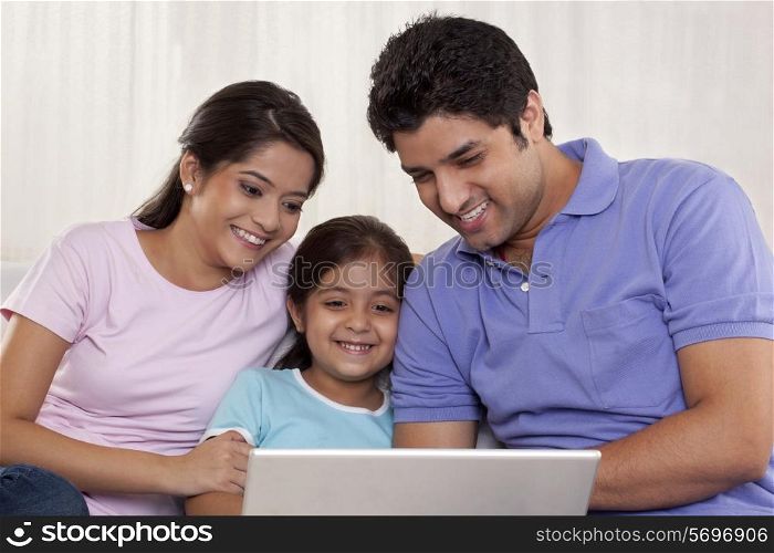 Happy family using laptop