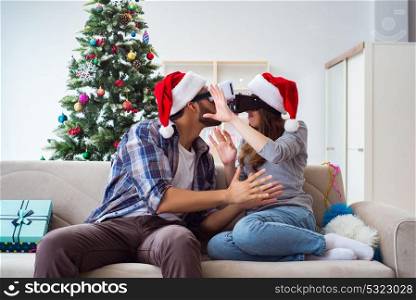 Happy family using virtual reality VR glasses during christmas