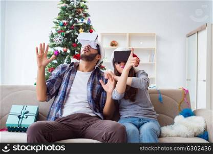 Happy family using virtual reality VR glasses during christmas. The happy family using virtual reality vr glasses during christmas