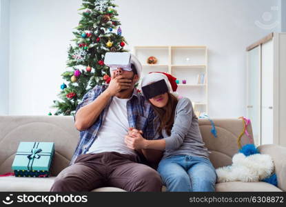 Happy family using virtual reality VR glasses during christmas