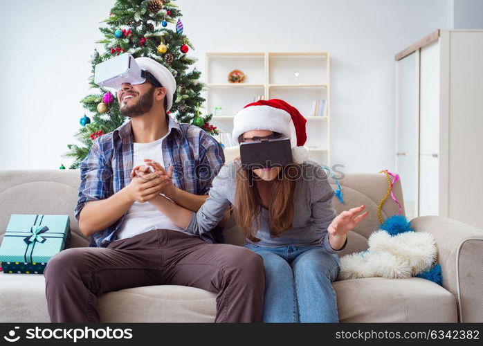 Happy family using virtual reality VR glasses during christmas