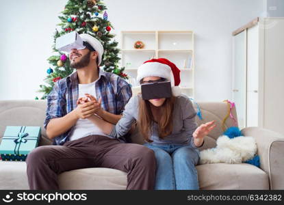 Happy family using virtual reality VR glasses during christmas