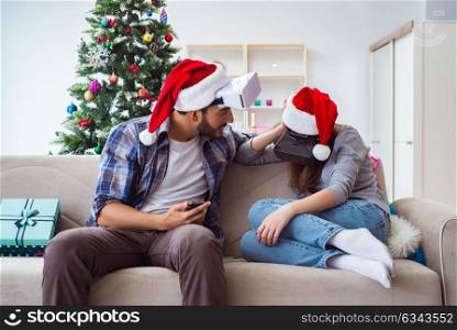 Happy family using virtual reality VR glasses during christmas
