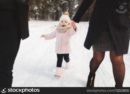 Happy family walking in the winter city park. Portrait of little cute daughter. Happy family walking in the winter city park. Portrait of little cute daughter.