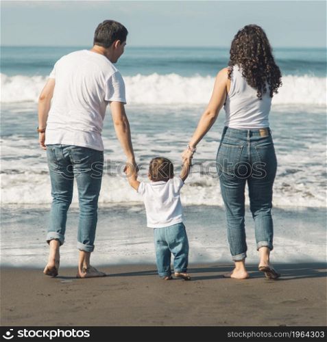 happy family with baby walking beach looking sea. High resolution photo. happy family with baby walking beach looking sea. High quality photo