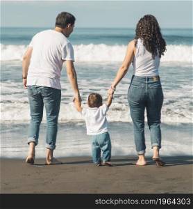 happy family with baby walking beach looking sea. High resolution photo. happy family with baby walking beach looking sea. High quality photo