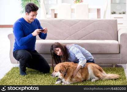 Happy family with golden retriever dog
