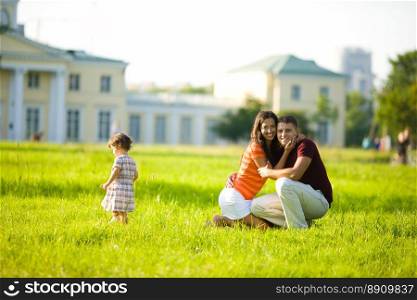 Happy Family with kid together outdoors summer evening