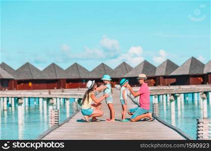 Happy family with kids on the beach vacation. Young family on vacation have a lot of fun
