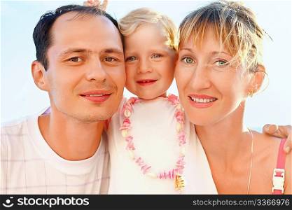Happy family with little girl near to sea, concerning with heads